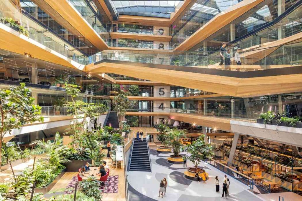 Booking.com Campus, Amsterdam, The Netherlands Fusing warm timber, light, and natural greenery across multi-level workspaces.