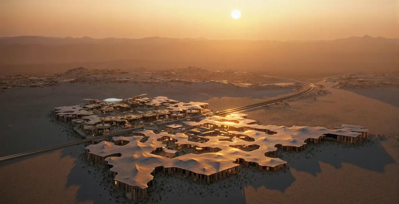 sweeping aerial of a desert resort at sunset